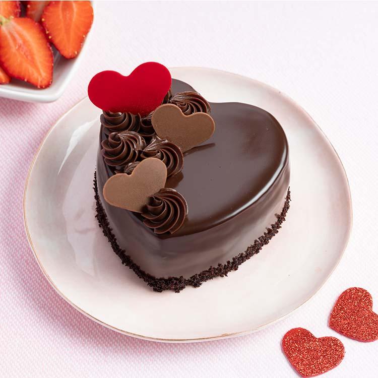 Heart-shaped chocolate cake ordered with a custom celebration message